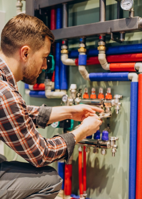 Young engineer adjusting autonomous heating